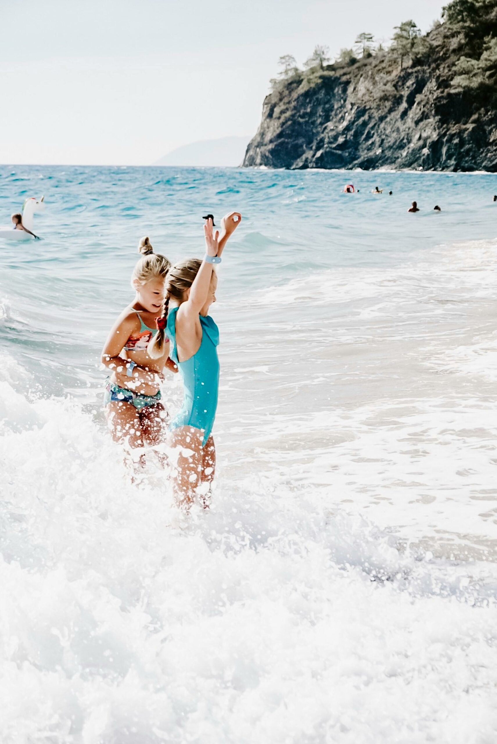 Girls splashing in waves at beach